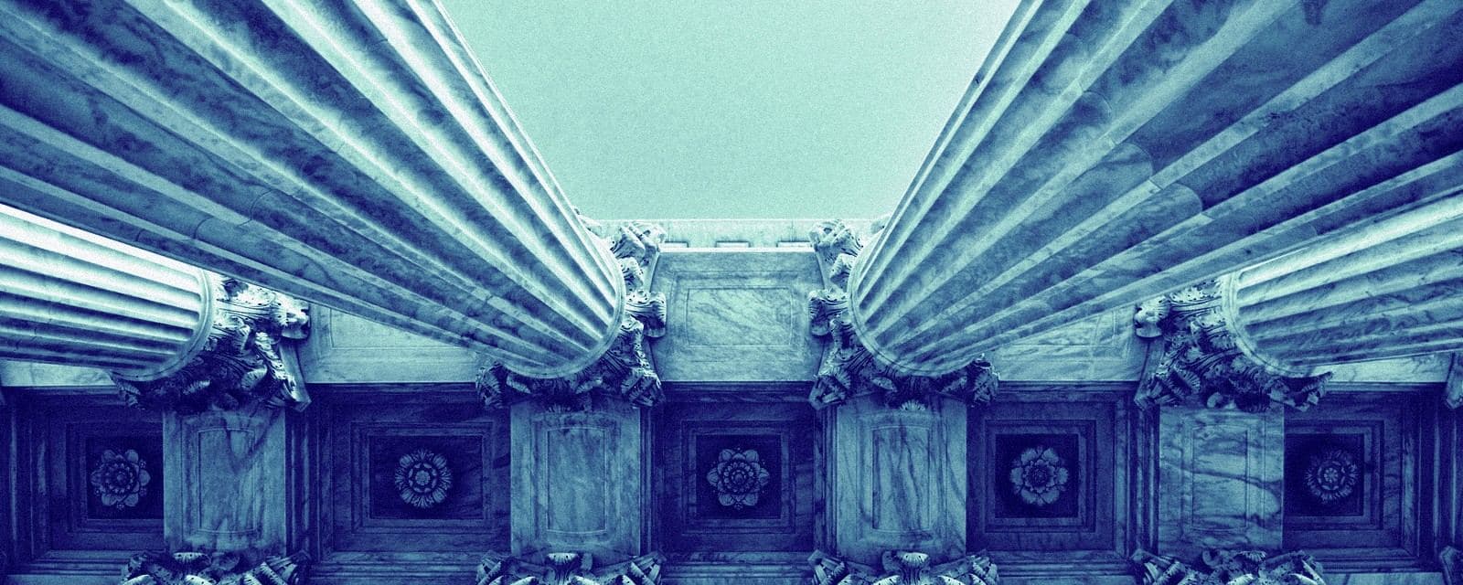Marble colonnade of a supreme court, looking up, editorial duotone treatment